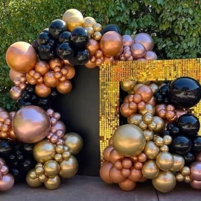 black and gold balloon decoration with square sequin backdrop